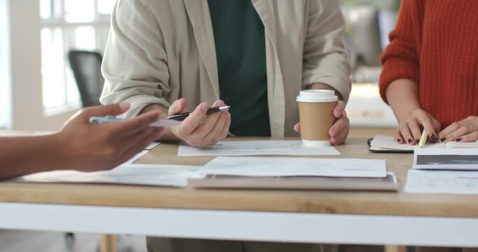 Left hand gesturing center pointing pen at papers on wood table right placing sticky notes aligning