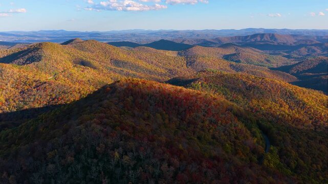 Fall season landscape of Appalachian mountains in North Carolina at sunset. Colorful forest canopies of autumn tones transform the surrounding countryside.