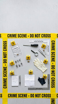 Crime Scene Investigation Evidence Collection with Yellow Caution Tape Fingerprints Magnifying Glass and Tools