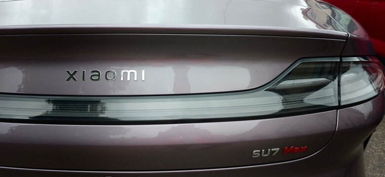 Russia, Saint Petersburg, September 11, 2026 - Close-up of the rear of a purple Xiaomi SU7 Max electric car. Chrome Xiaomi badge, modern tail light, glossy body.