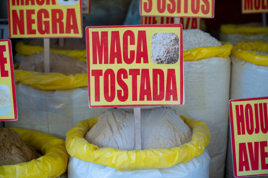 Toasted maca powder displayed at the Mercado Mayorista in Huancayo, Peru. Close-up of a large open sack of roasted maca powder with a Spanish product sign.
