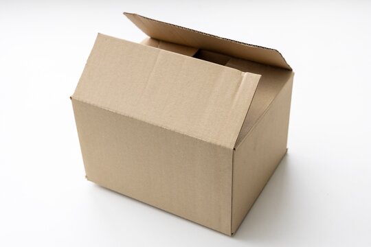Simple empty brown corrugated cardboard box with open flaps on white background