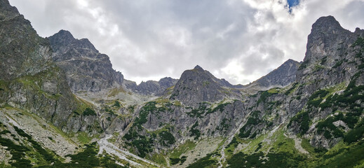 Rocky peaks of Slovak Tatras above mountain pine slopes on way to Zielony Staw Kiezmarski © Liubou