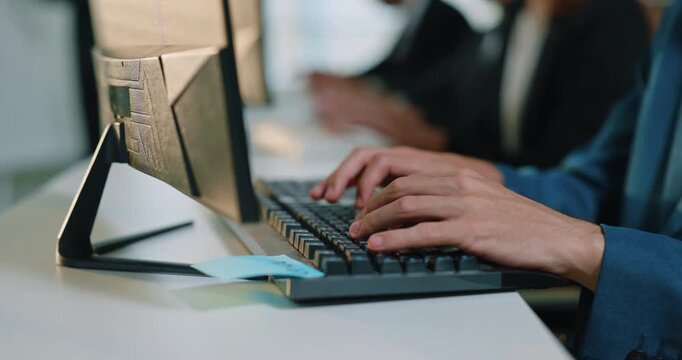 Hands type on keyboard near desktop monitor during office routine. Focused worker enters data keeping steady rhythm while completing focused computer task