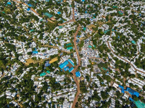 Ukhia, Bangladesh - 14 October 2026: Aerial view of Rohingya Camp E-Block, showing dense clusters of makeshift shelters with white tarpaulin roofs and narrow dirt paths.