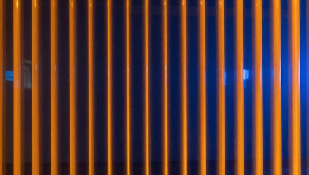 Abstract pattern of vertical orange lines against a dark blue background