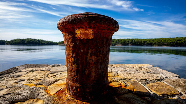 Iron mooring bollard, calm sea, concrete shore, clear sky, Mediterranean, Adriatic Sea, no people, early autumn