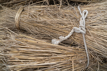 Rice straw bundle tied with a rope seen from above © kt