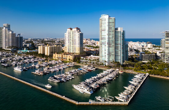 Miami skyscrapers coastline in Miami. Aerial drone sailboat and yachts near Miami marine. Miami skyline. Cruise yacht in marina. Yachts and sailboats for summer trip.