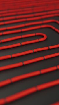 Red pipes on dark floor. Construction of underfloor heating system. Animation of water pipes for house warming. Radiant hydronic heating. Vertical Video.