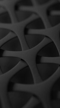 Macro of black synthetic fabric with an interwoven mesh. Advanced textile technology. 3D animation loop. Vertical Video.