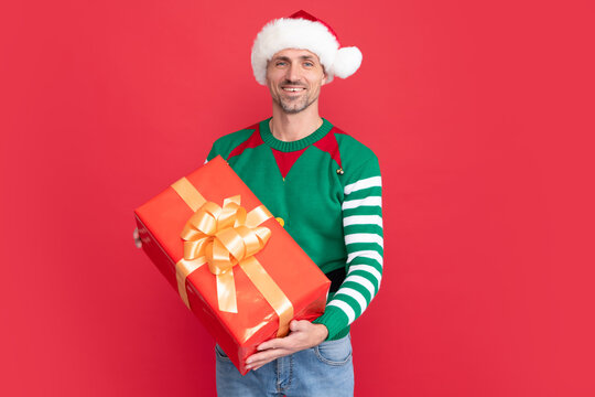 xmas guy show present box on red background. happy new year. merry christmas gift.