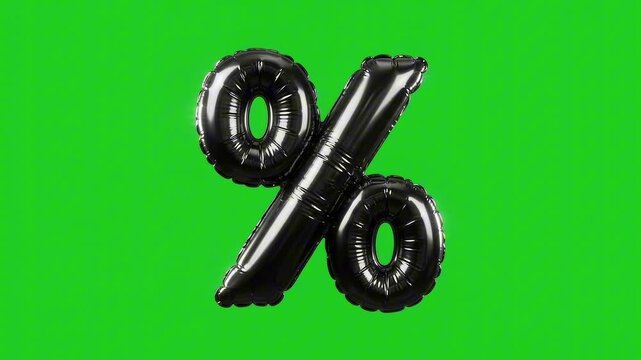 Black inflatable percentage sign balloons floating on a green background. This image is perfect for representing sales, discounts, or promotions