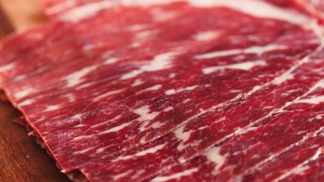 Beef cecina, marbled cured beef slices close up, spanish jamon style cured ham, cured meat like iberico pork ham and prosciutto for tapas and cold cuts