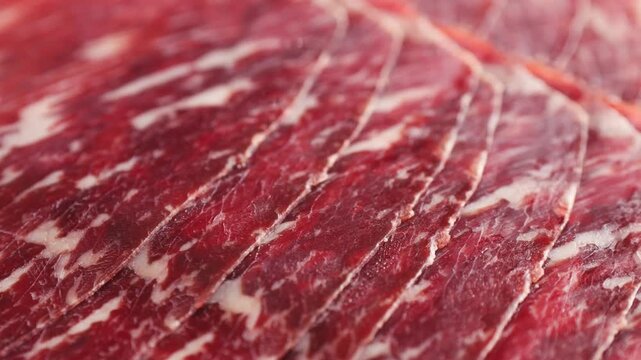 Beef cecina, marbled cured beef slices close up, spanish jamon style cured ham, cured meat like iberico pork ham and prosciutto for tapas and cold cuts