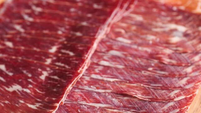 Beef cecina, marbled cured beef slices close up, spanish jamon style cured ham, cured meat like iberico pork ham and prosciutto for tapas and cold cuts