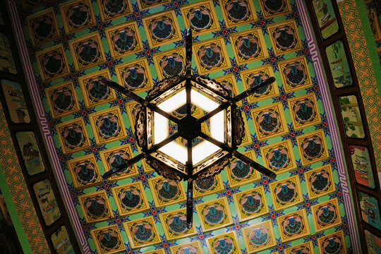 Hexagonal lantern under a colorful coffered ceiling, Chinese Garden Zurich, Switzerland