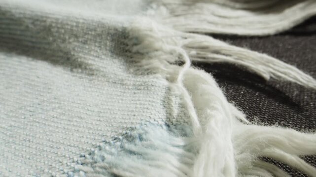 Wool scarf with fringe, close up of knitted white and black striped woolen textile, cozy handmade blanket texture with tassels for winter fashion and textile production