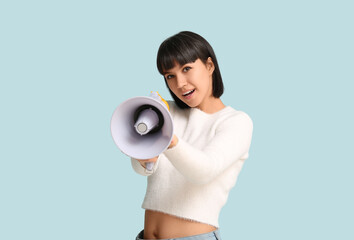 Communication and announcement, young woman shouting into a megaphone to share news or protest for...