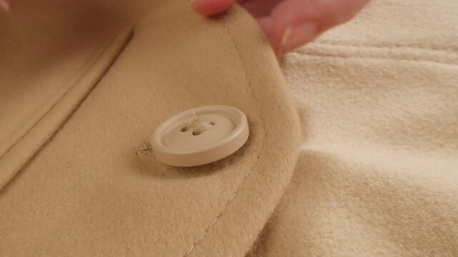 Beige wool background, natural sheepskin close-up macro coat. Top view