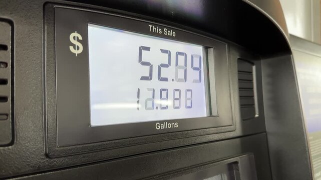 Close-up view of a modern gas pump digital screen displaying a total sale price and gallons pumped at a fuel station. Ideal for topics on gas prices and energy costs.