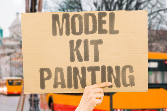 "Model kit painting" Hobbyists snip plastic, glue tiny parts, and apply washes, decals, and steady breath to finish miniature planes, tanks, and cars. MODEL. KIT. PAINTING. HOBBYISTS. MINIATURES.