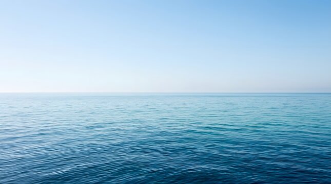 Calm blue ocean surface with gentle waves under a clear sky, minimalist seascape composition