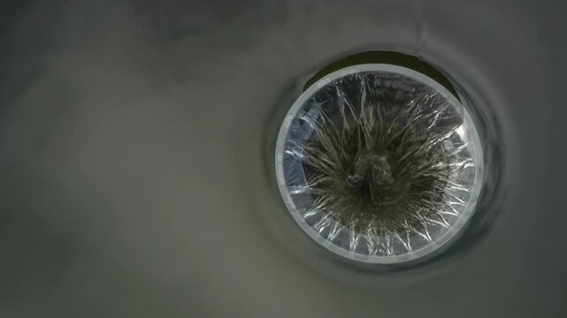 Water Being Sucked into an Industrial Drain Pipe, Close Up of Circular Water Vortex