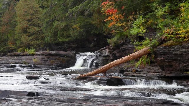 Water flowing over rocks in Black river national forest in michigan upper peninsula during autumn.