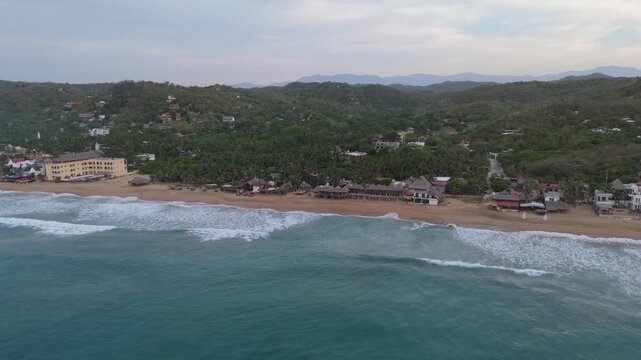Aerial view along Zipolite beach with waves Oaxaca Mexico