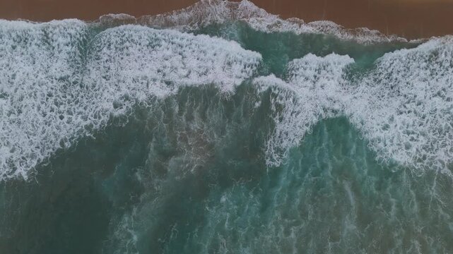 Top down aerial of turquoise water and breaking wave crests Oaxaca