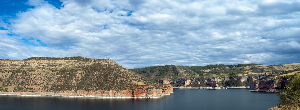 Panorama of the colorful cliffs surrounding Bighorn Lake near Okebah Marina at Fort Smith, Montana, USA