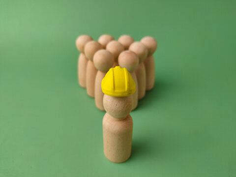 Yellow Hard Hat Figure Leading a Pyramid Group