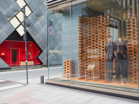 TOKYO, JAPAN - October 13, 2026: Display of the window of the Ginza Tower branch of Emporio Armani. There is a Bottega Veneta store on the opposite it.