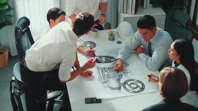 Top view of professional engineer showing and talking about turbine engine design. Aerial view of skilled designer or technician group explain about electronic generator construction. Alimentation.