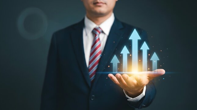 Businessman in suit holding glowing digital growth arrows in palm