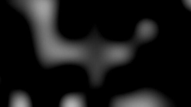 Abstract blurred light patches shifting on a dark background with black background continuous