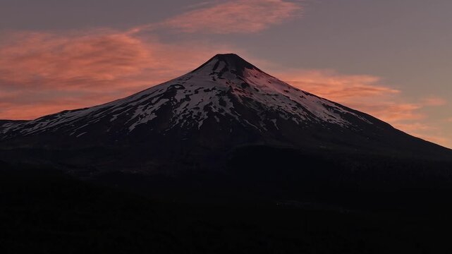 Villarrica volcano under pink sunset sky, aerial, Pucon, Chile