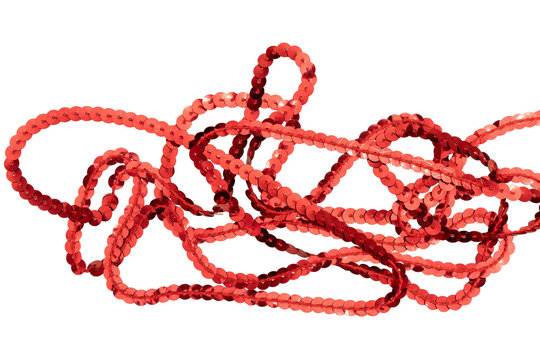 Tangled red sequin trim strands close up isolated on transparent PNG