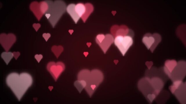 Heart shaped bokeh particles floating on dark background valentine loop