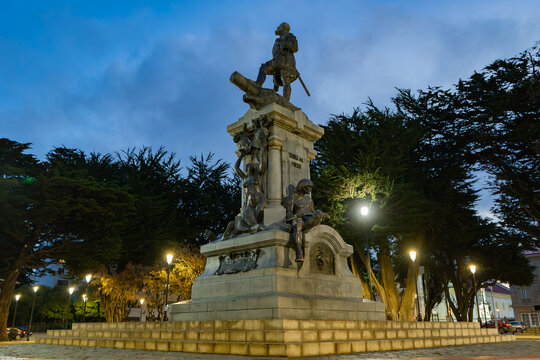 Bronze monument of Ferdinand Magellan illuminated at night