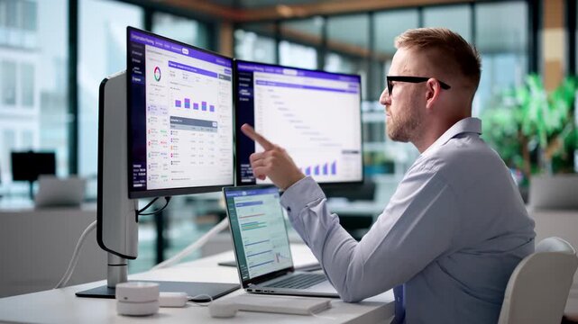 HR Manager Is Reviewing Compensation Data On Laptop