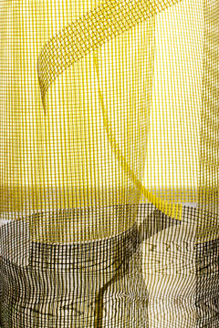 Abstract background made of yellow mesh material