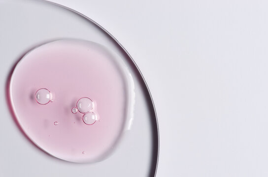 Pink cosmetic product for skin care. A serum or body gel or a moisturizer. Copy space