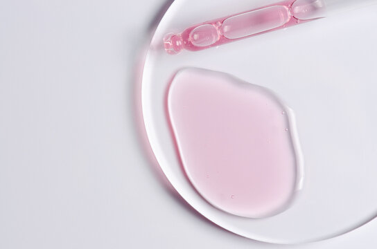Pink cosmetic product for skin care. A serum or body gel or a moisturizer. Copy space