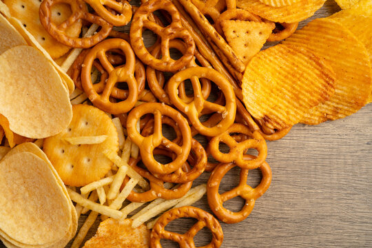 Mix of variety snack chips pretzel and cracker, junk crunchy food.