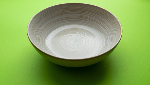 Minimal White Bowl on Bright Green Surface.