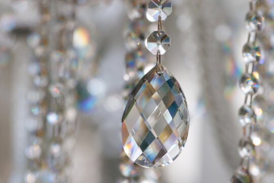 Crystal droplet hangs from a chandelier