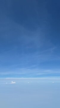 4k footage real time airplane flying in the clear blue sky and clouds 