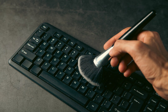 Keyboard and brush on a dark background.